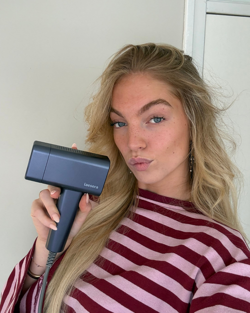 Vrouw houdt de Laesera Nova One IPL vast tijdens gebruik